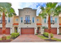 Charming two-story townhome featuring a private garage, balcony, and lush landscaping at 3222 W Empedrado St, Tampa, FL 33629
