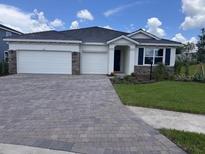 Charming single-story home featuring a brick-paved driveway and a two-car garage at 4327 Pullet Ct, Lakewood Ranch, FL 34211