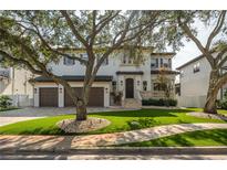 Charming two-story home with a three-car garage and beautifully landscaped front yard at 5020 W Dickens Ave, Tampa, FL 33629