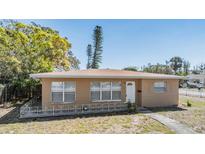 Charming single-story home featuring a well-manicured lawn and cozy front porch at 5130 Dr Martin Luther King Jr St S, St Petersburg, FL 33705