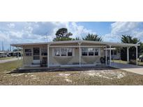 Charming single-story home with a covered porch and carport, providing convenient outdoor space and parking at 35138 Dale Ave, Zephyrhills, FL 33541