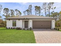Charming one-story home with a two-car garage and a beautifully paved driveway at 3355 Moncrief Ave, North Port, FL 34286