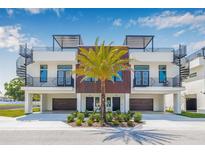 Modern townhome featuring a rooftop terrace, spiral staircase, wood accents, and a well-manicured front yard at 460 87Th Avenue North, St Petersburg, FL 33702