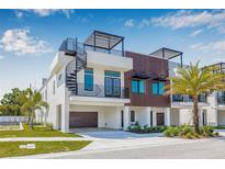 Modern three-story home featuring a spiral staircase and rooftop deck with sleek, contemporary design elements at 8631 5Th Street North, St Petersburg, FL 33702