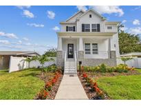 Charming two-story home featuring a beautifully landscaped front yard with a welcoming walkway at 441 42Nd Ne Ave, St Petersburg, FL 33703
