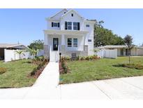 Charming two-story home with landscaped front yard and elegant entryway with a stairway up to the front door at 441 42Nd Ne Ave, St Petersburg, FL 33703
