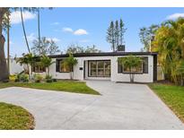 Charming single-story home with a well-manicured lawn and inviting front entrance at 4210 Harrisburg Ne St, St Petersburg, FL 33703