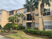 Three-story condo building with private screened-in balconies and lush, tropical landscaping at 5125 Palm Springs Blvd # 10303, Tampa, FL 33647