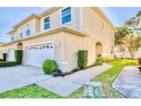 Charming two-story townhome with attached garage and landscaped walkway to the front door at 11056 63Rd Ave, Seminole, FL 33772