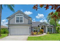 Beautiful two-story home with a two car garage, lush landscaping, and an inviting front porch at 16218 Swenson Ter, Lutz, FL 33549