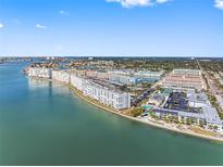 Expansive aerial view of waterfront condos and a marina on a sunny day with blue sky and sea at 3010 59Th S St # 304, Gulfport, FL 33707