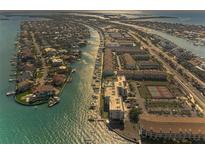 Breathtaking aerial view of waterfront homes and condos with boat docks along the tranquil waterway at 363 Pinellas Bayway S # 41, St Petersburg, FL 33715