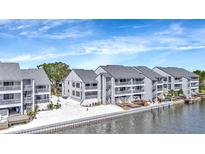 Waterfront condo buildings featuring balconies and decks on a sunny day with a waterfront view at 813 Bahia Del Sol Dr # 33, Ruskin, FL 33570