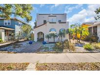 Charming home featuring a stucco exterior, arched windows, and a well-manicured front yard with tropical landscaping at 2528 3Rd N Ave, St Petersburg, FL 33713