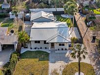 Stunning aerial view of a well-maintained home with a metal roof, manicured lawn, and inviting curb appeal at 7218 Park S St, St Petersburg, FL 33707