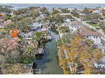 Breathtaking aerial view of waterfront homes with private docks along a serene canal leading to the open bay at 4829 W San Miguel St, Tampa, FL 33629