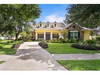Charming home featuring manicured landscaping, stone accents, and a welcoming front porch at 4023 W Horatio St, Tampa, FL 33609