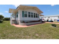 Charming single-story home with a well-maintained lawn, flower beds and carport at 112 Saint Pierres Way, Apollo Beach, FL 33572