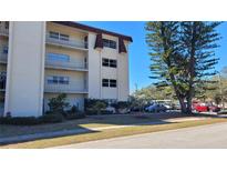Four-story building with balconies, windows, and a parking area on a sunny day at 209 Ne Lincoln N Cir # 109, St Petersburg, FL 33702