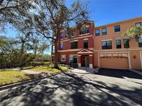 Inviting multi-story townhome with a well-manicured lawn and attached two car garage at 2757 Via Cipriani # 1114A, Clearwater, FL 33764