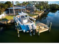 Stunning waterfront home with a private dock and boat lift, perfect for enjoying waterfront living at 3998 South Cir, Largo, FL 33774