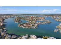 Beautiful aerial view of waterfront homes in Treasure Island, Florida, with stunning water views and lush landscaping at 10128 Paradise Blvd, Treasure Island, FL 33706