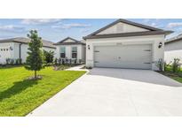 Charming single-Gathering home featuring a two-car garage, well-maintained lawn, and welcoming curb appeal at 4306 Big Sky Dr, Spring Hill, FL 34604
