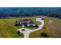 Expansive home and large detached garage, with circle drive on a well-manicured acreage at 6367 Foxbrook Trl, Parrish, FL 34219
