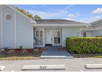 Charming single-story home with covered entrance, light blue siding, and a well-maintained front yard at 16211 Rambling Vine W Dr, Tampa, FL 33624