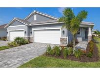 Charming home showcasing a three-car garage, well-manicured lawn, and a welcoming paved walkway leading to the front door at 18491 Green Garden Ct, Venice, FL 34293
