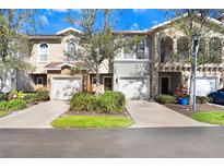 Townhouse-style condominiums showcase attached garages, arched entryways and well-maintained landscaping at 310 Summer Clouds Pl, Brandon, FL 33511