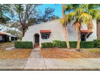 Charming condo featuring a well-maintained exterior with a cozy entrance and beautiful landscaping at 3505 Tarpon Woods Blvd # K406, Palm Harbor, FL 34685