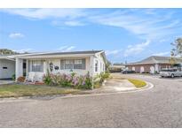Lovely single-story home featuring well-kept landscaping and covered entrance at 5006 Springwood N Ave # 119, Pinellas Park, FL 33782