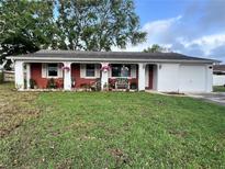 Charming single-story home featuring a brick facade and manicured front lawn at 3108 Ash Ct, Dunedin, FL 34698