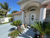 Inviting front entry with manicured landscaping, decorative columns, and charming lion statues at 6190 107Th N Ave, Pinellas Park, FL 33782