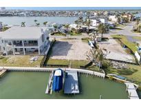 Waterfront lot featuring a boat dock, lift and boat, ready for your new custom home at 211 Bath Club N Blvd, North Redington Beach, FL 33708