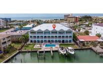 Stunning waterfront home with a pool, boat dock, and gulf views from multiple floors at 11721 1St E St, Treasure Island, FL 33706