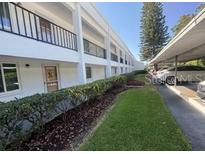 Two-story condo with covered parking, landscaping, and well-maintained grounds at 2060 Marilyn St # 133, Clearwater, FL 33765