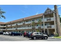 Multi-story condo building featuring decorative balconies and well-maintained landscaping on a sunny day at 2311 Brisbane St # 65, Clearwater, FL 33763
