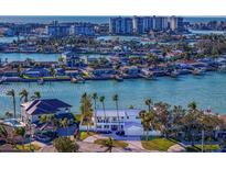 Stunning aerial view of waterfront home with lush landscaping and ocean view of the city skyline in the background at 7810 10Th S Ave, St Petersburg, FL 33707