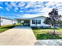 Charming single-story home features a covered carport and a well-maintained lawn at 37544 Corey Lewis Ave, Zephyrhills, FL 33541