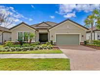 Charming single-story home with a tile roof, well-manicured landscaping, and a two-car garage at 8733 Sorano Villa Dr, Tampa, FL 33647