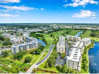 Beautiful aerial view of condo community, lush landscaping, golf course, and picturesque waterway at 960 Starkey Rd # 10301, Largo, FL 33771