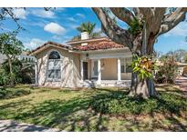 Attractive home with a covered front porch, a charming entrance, and a nicely landscaped yard at 1370 Brightwaters Ne Blvd, St Petersburg, FL 33704