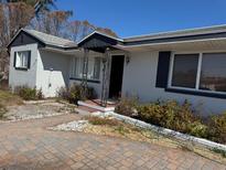 Charming single-story home with a well-manicured lawn and inviting front porch at 8075 Gulf Blvd, St Pete Beach, FL 33706
