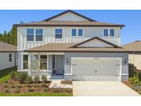 Charming two-story home featuring a two-car garage and beautifully landscaped front yard at 36424 Sespe Creek Ct, Zephyrhills, FL 33540