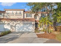 Charming two-story home with a red tile roof, two-car garage, and landscaped front yard at 6211 S Macdill Ave # 1, Tampa, FL 33611