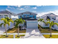 Beautiful two-story light blue home with a modern design and well-manicured landscaping at 6538 Simone Shores Cir, Apollo Beach, FL 33572