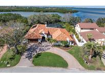 Stunning waterfront home with lush landscaping, brick drive, and private pool at 1401 75Th Ne Cir, St Petersburg, FL 33702