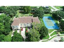 A charming community featuring a tennis court, water features, mature trees, and convenient parking at 102 Brent Cir, Oldsmar, FL 34677